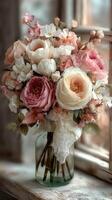 Beautiful bouquet of pink and white roses arranged in a vintage glass jar near a window in soft natural light photo