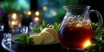 Refreshingly brewed iced tea served with lemon slices and mint in a serene evening setting photo