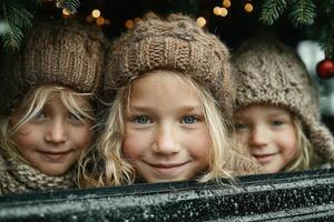 Three children with bright eyes enjoying winter festivities from behind a festive display in a cozy atmosphere photo