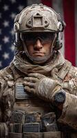 Soldier in uniform shows respect while standing in front of American flag photo