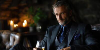 Sophisticated man enjoying whiskey in a dimly lit lounge during evening hours photo