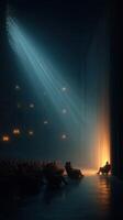 Audience waits attentively in a dimly lit theater with dramatic light illuminating the stage photo