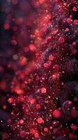 Vibrant red and gold bokeh lights create a mesmerizing abstract background from a close-up view of sparkling particles photo