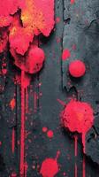 Vibrant red paint splatter on textured black wall showcasing raw artistic expression photo