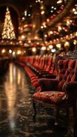 Elegant theater seats lined up in a festive venue with holiday lights in the background photo