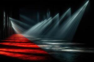 Light beams illuminate a red carpet path in a dramatic dark venue setting for an exclusive event or performance photo