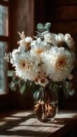 Floral arrangement in glass vase with soft lighting showcasing white and cream flowers in a cozy indoor setting during afternoon photo