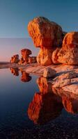 Stunning rock formations reflect in tranquil water at sunset in a serene location photo