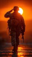 Soldier salutes at sunset, embodying bravery and dedication in the warm glow of the setting sun photo