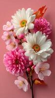 Colorful arrangement of flowers on pink background showcasing spring blooms and vibrant petals photo