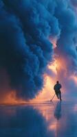 Ice hockey player practices in dramatic smoke at dusk on frozen rink in winter photo