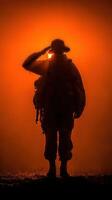 Soldier salutes against a dramatic sunset backdrop in a moment of reflection photo