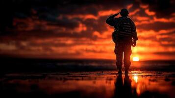 Soldier saluting at sunset on a beach during a reflective moment in quiet solitude photo