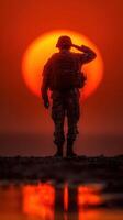 Soldier saluting the sunset on a calm evening at the military base during twilight hours photo