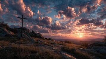 Beautiful sunset at a mountain cross with colorful clouds and serene landscape in the background photo