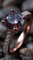 Stunning rose gold engagement ring featuring a large gemstone and sparkling smaller stones set against a textured background photo
