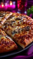 Delicious mushroom pizza served on a black plate at a cozy dining table with candles and vibrant decor photo