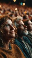 Audience watches intently during a performance in a theater setting, showcasing diverse emotions and engagement photo