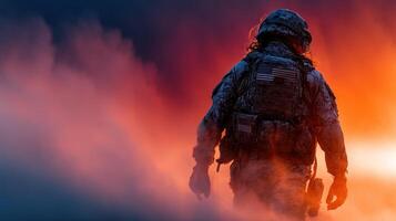 Soldier walking through smoke at sunset during military training exercise in a desolate landscape photo
