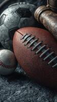 Collection of sports balls including a football, baseball, and soccer ball displayed on a textured surface photo