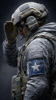 Soldier salutes with respect in cold environment, showcasing armor and detailed military insignia at night photo