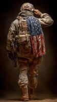 Soldier saluting with American flag draped over shoulders in a somber setting photo
