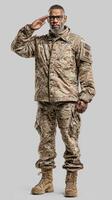 Military personnel in camouflage uniform saluting with respect in a neutral setting photo