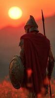 Warrior standing tall against the sunset with shield and spear in an ancient landscape photo