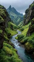 Stunning green valley with a winding river surrounded by towering cliffs in Iceland during an overcast day photo