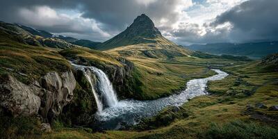 Majestic Kirkjufell mountain with a cascading waterfall and serene river under a dramatic sky in Iceland during early morning light photo