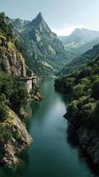 Scenic river winding through mountains at midday with lush greenery reflecting on calm water photo