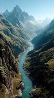 Majestic river winding through rugged mountain valley under clear blue sky in early morning light photo