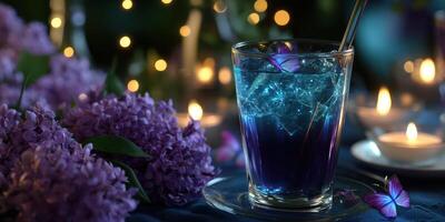 Vibrant drink surrounded by lilacs and candles creates a magical nighttime ambiance photo