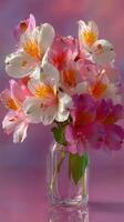 Colorful bouquet of pink and white flowers arranged in a clear glass jar on a softly blurred background photo