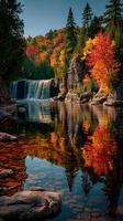 Autumn colors reflected in tranquil lake with waterfall and vibrant foliage in serene natural landscape photo