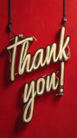 Bright thank you sign against a red wall creates a warm atmosphere for appreciation photo