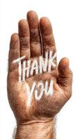 Hand displaying a message of gratitude with a scribbled thank you on the palm photo