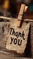 Handwritten thank you note attached to wooden surface with clothespin lends warmth to rustic decor photo