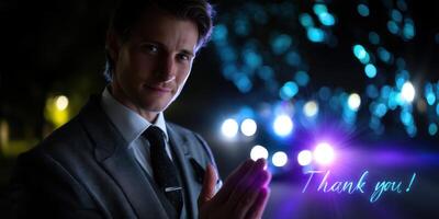 Elegant man expressing gratitude at a nighttime gathering with glowing lights in the background photo