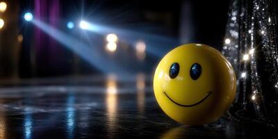 Bright yellow smiley face ball on stage with dramatic lighting during a performance at a vibrant venue photo