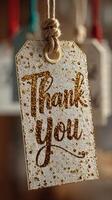 Thank you tags hanging with glitter detail in a cozy interior setting photo