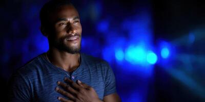 Man expresses emotions in a dimly lit space with blue lighting at night during a personal reflection moment photo