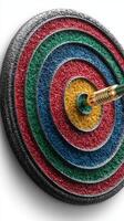 Brightly colored dartboard with a dart striking the bullseye in a focused indoor setting photo