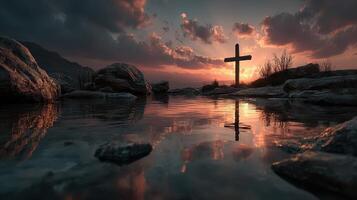 Sunset casts reflection of cross near serene waters surrounded by rocky landscape in peaceful evening photo