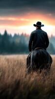 Cowboy riding a horse through tall grass at sunset, surrounded by nature's tranquility photo