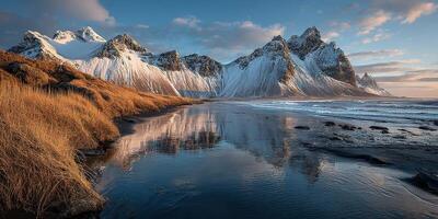 Stunning winter landscape at Vestrahorn mountain reflecting in calm waters at sunset in Iceland photo