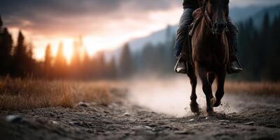 Horse rider gallops through a dusty trail at sunset in a tranquil landscape surrounded by nature photo