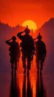 Soldiers saluting at sunset against a vibrant orange sky in a mountainous landscape photo