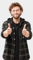 Man smiling and giving thumbs up in casual outfit expressing positivity in a neutral background photo