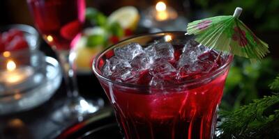 Refreshing cocktail with ice and colorful garnish served in a dimly lit setting photo